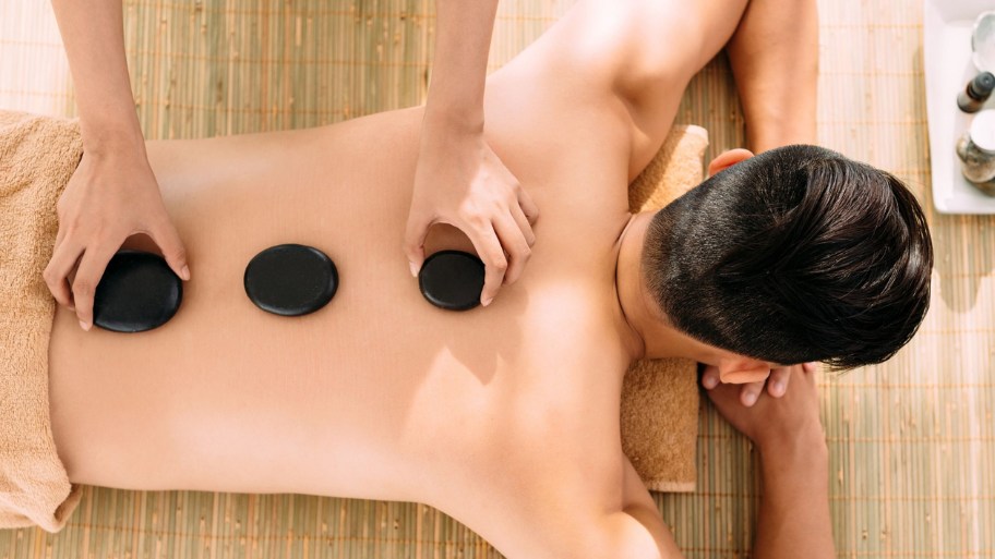 A back massage hot stone treatment may help reduce stress and promote relaxation by easing muscle tension and discomfort