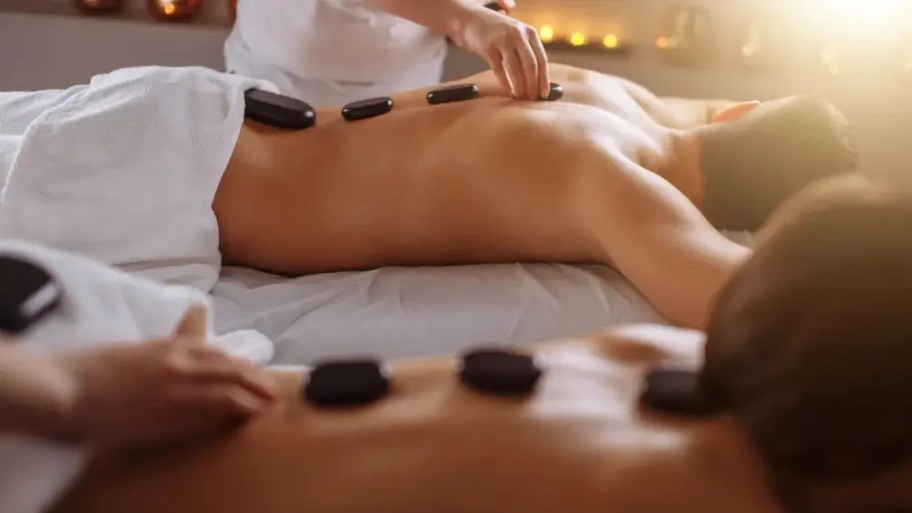 The therapist applies steady, rhythmic pressure to the back and shoulders to release muscle knots and stiffness
