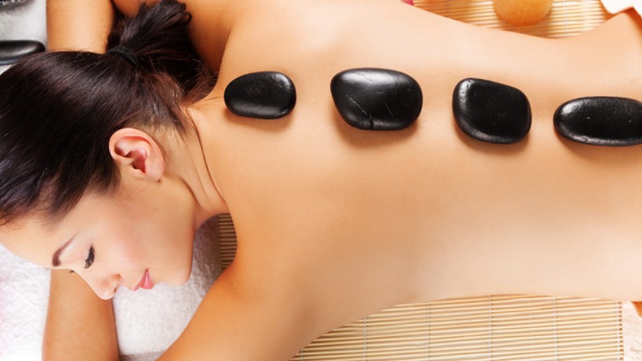 A hot stone back massage may help by combining therapeutic touch with soothing heat to ease muscle tension and discomfort