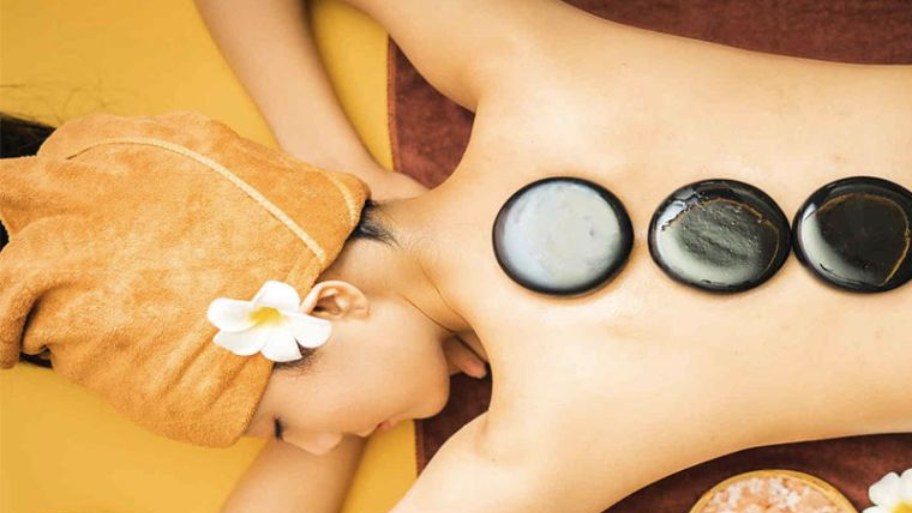 Hot stone massage is a spa treatment that uses heated smooth stones combined with massage techniques